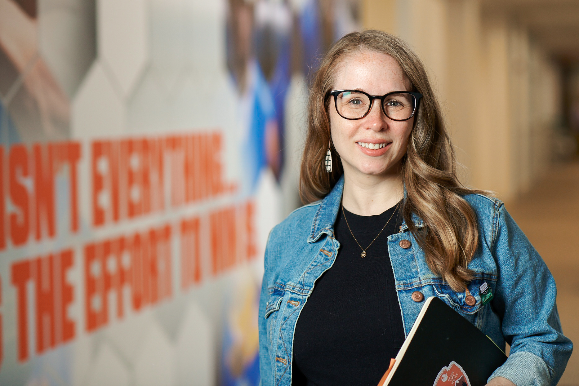 Kristin Anderson standing in front of a mural